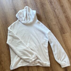 white cream sweatshirt that is soft and in good barley worn condition